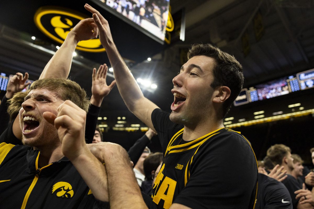 Iowa forward Alvaro Folgueiras yells out and high-fives fans during a basketball game between the Iowa Hawkeyes and the No. 9 Nebraska Cornhuskers at Carver-Hawkeye Arena on Tuesday, Feb. 17, 2026. The Hawkeyes upset the Cornhuskers, 57-52. (Samantha DeFily/The Daily Iowan)