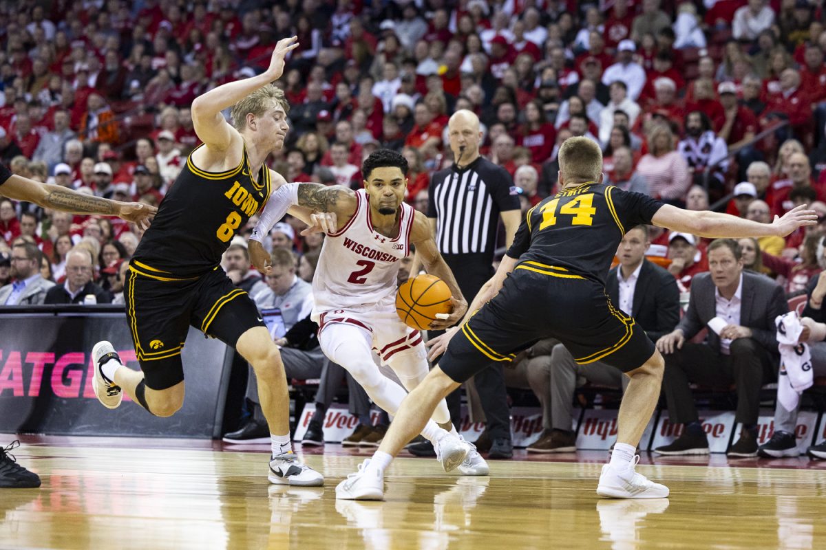 Iowa forward Cooper Koch and guard Bennett Stirtz attempt to block Wisconsin guard Nick Boyd’s path to the basket during a basketball game between the Iowa Hawkeyes and the No. 24 Wisconsin Badgers at the Kohl Center in Madison, Wisconsin on Sunday, Feb. 22, 2026. The Hawkeyes fell to the Badgers, 84-71. (Samantha DeFily/The Daily Iowan)