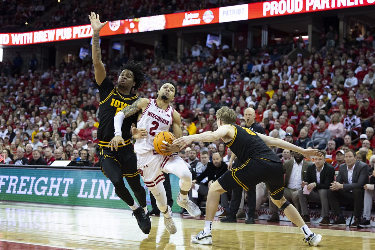 Wisconsin guard Nick Boyd attempts to get past Iowa guard Tavion Banks and forward Cooper Koch during a basketball game between the Iowa Hawkeyes and the No. 24 Wisconsin Badgers at the Kohl Center in Madison, Wisconsin on Sunday, Feb. 22, 2026. The Hawkeyes fell to the Badgers, 84-71. (Samantha DeFily/The Daily Iowan)