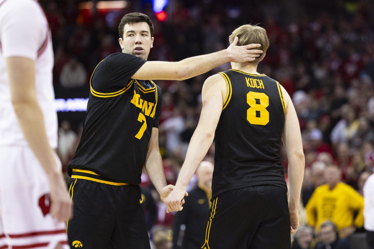 Iowa forward Alvaro Folgueiras pats the back of Iowa forward Cooper Koch’s head during a basketball game between the Iowa Hawkeyes and the No. 24 Wisconsin Badgers at the Kohl Center in Madison, Wisconsin on Sunday, Feb. 22, 2026. The Hawkeyes fell to the Badgers, 84-71. (Samantha DeFily/The Daily Iowan)