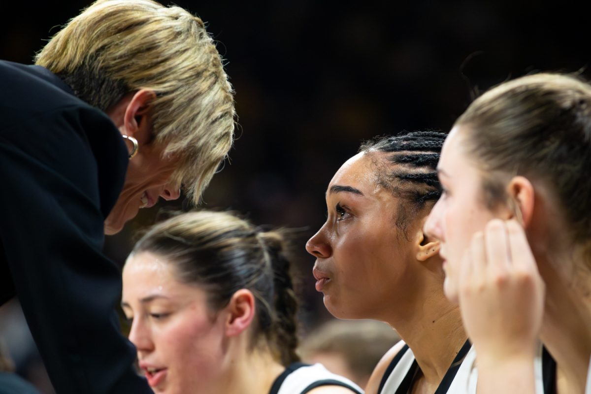 Iowa head coach Jan Jensen talks to Iowa senior forward Hannah Stuelke on the bench in tears at the game between No. 9 Iowa vs Illinois at Carver-Hawkeye Arena on Thursday, Feb. 26, 2026. Stuelke came back from the injury and played the rest of the game, putting up 18 points. Iowa scraped by Illinois 82-78 to propel them to a record of 23-5. (Travis Crabb/The Daily Iowan).