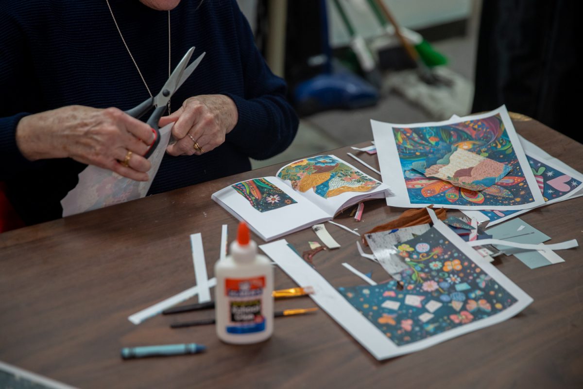 A participant tries their hand at a Junk Journaling class at ArtiFactory in Iowa City, Iowa. The class is an opportunity for participants to learn how to repurpose old magazines and newspapers with cutouts. (Danny Enright/The Daily Iowan)