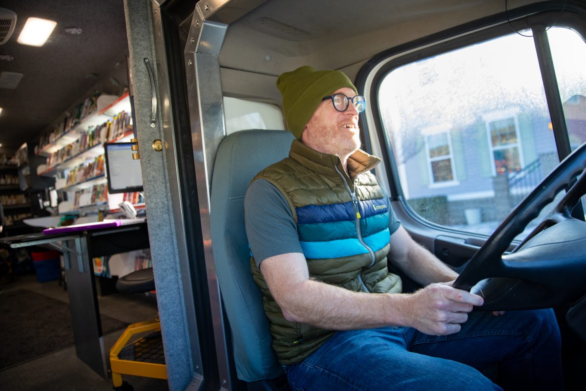 Tom Jordan sits in the driver’s seat of the Iowa City Public Library BookMobile in Iowa City on Monday, Jan. 26, 2026. The BookMobile has multiple stops a week and can stock books by request. (Ava Neumaier / The Daily Iowan)
