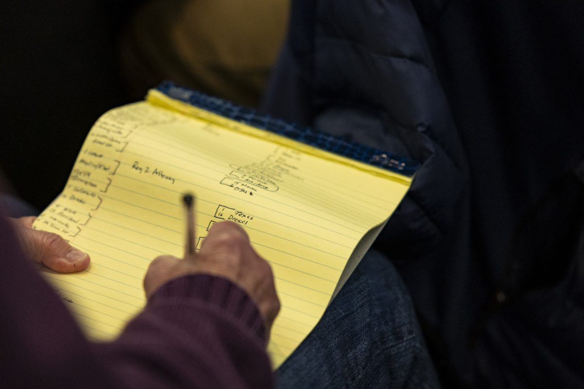 A journalist writes out a bracket during a Selection Show watch party with the Iowa women’s basketball team in the Feller Club Room at Carver-Hawkeye Arena in Iowa City, Iowa, on Sunday, March 17, 2024.