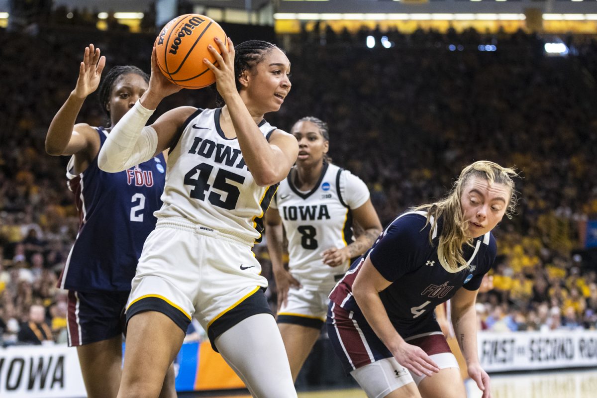 Iowa Hawkeyes forward Hannah Stuelke (45) looks to pass the ball after rebounding during a basketball game between the No. 2 seed Iowa Hawkeyes and the No. 15 seed Fairleigh Dickinson Knights at Carver-Hawkeye Arena in Iowa City, Iowa, on Saturday, March 21, 2026. The Hawkeyes defeated the Knights, 58-48.