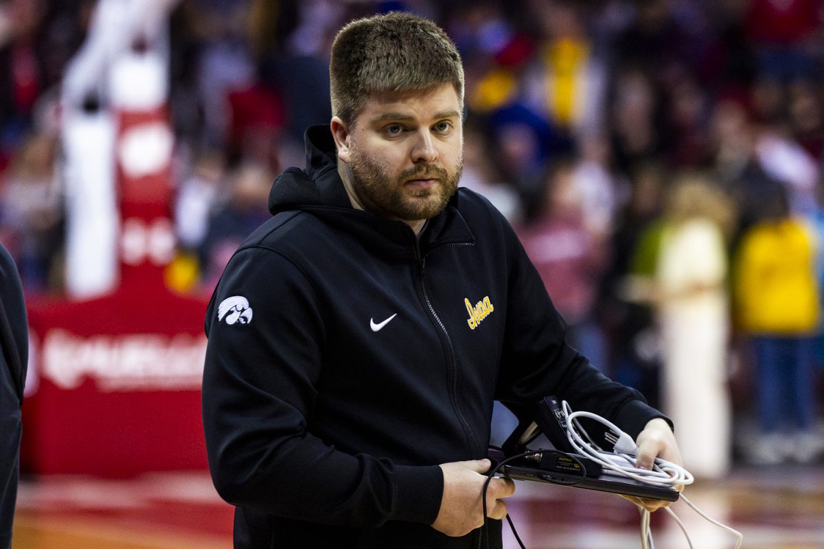 Iowa Video Coordinator and Director of Analytics, Ben Lober, watches intently during a basketball game between the No. 9 Iowa Hawkeyes and the Wisconsin Badgers at the Kohl Center in Madison Wisconsin on Sunday, Mar. 1, 2026. Lober oversees all scouting video operations for the analytic side of the program. This is Lober’s fourth season with Iowa Women’s Basketball.