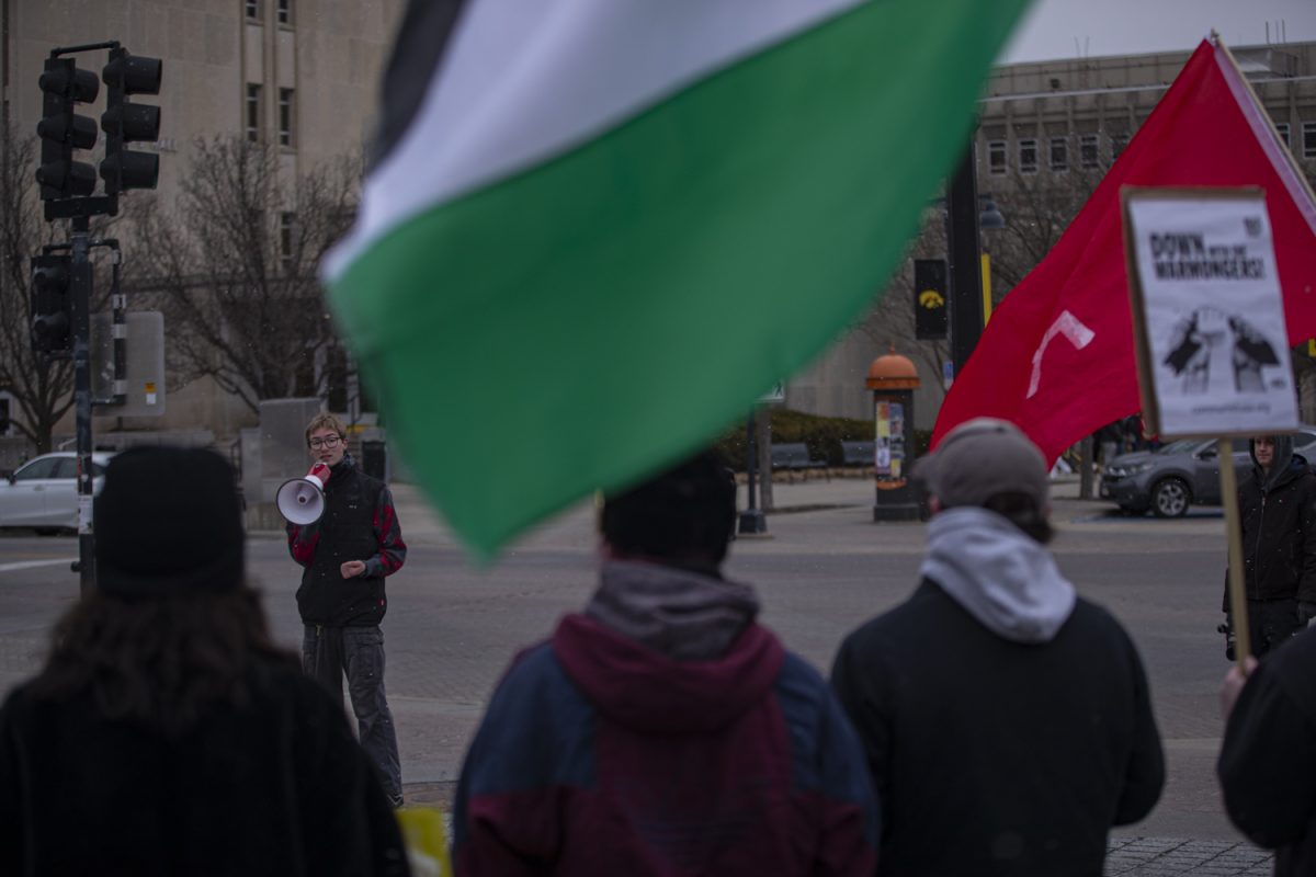 Protest organizer Jonah Cornelisse speaks into a megaphone on the University of Iowa’s Pentacrest, campaigning against the US’s attack on Iran on Sunday, March 3, 2026, in Iowa City, Iowa. The event, organized by the University of Iowa’s chapter of the Young Democratic Socialists of America, included many protestors affiliated with the Revolutionary Communists of America organization.