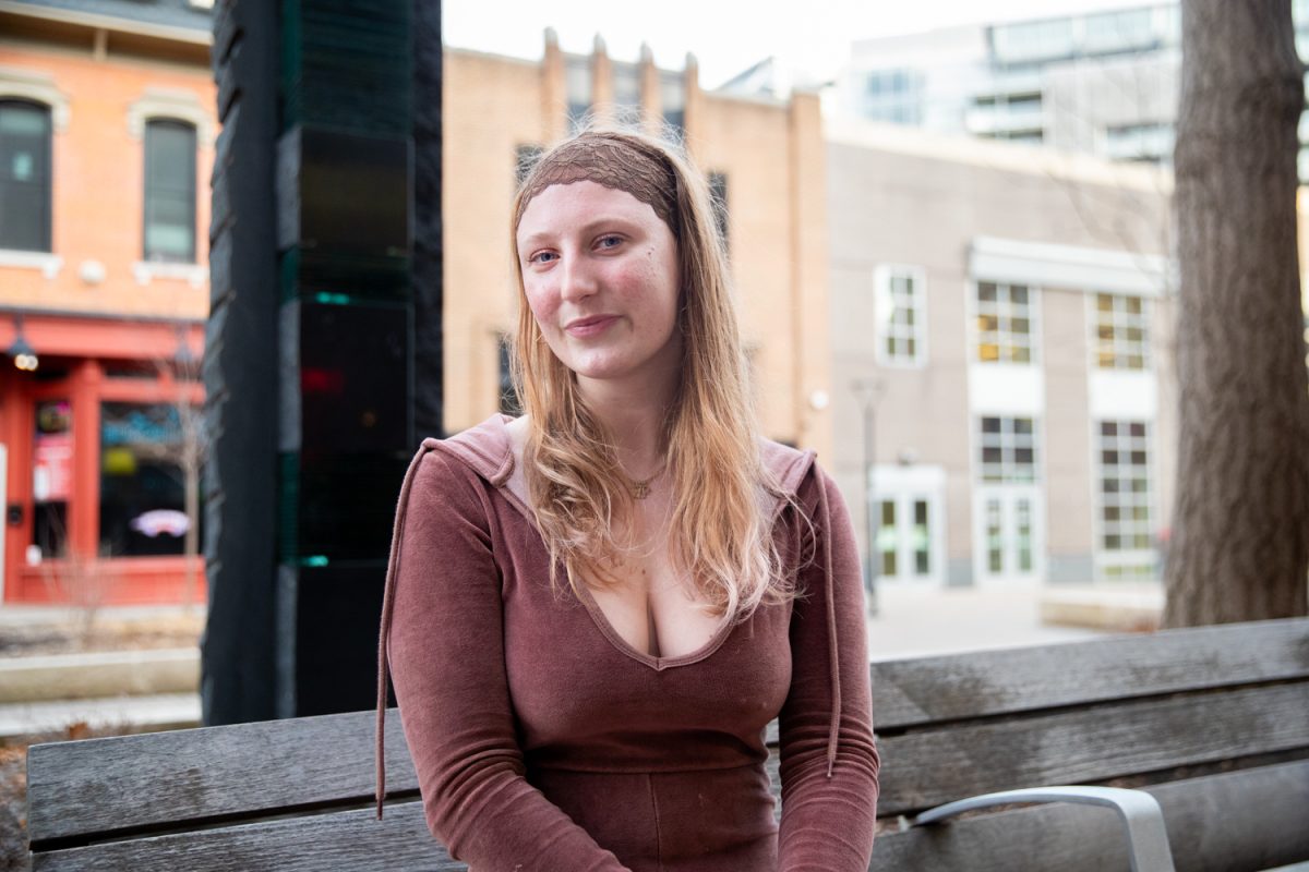 University of Iowa Gender, Women's, and Sexuality Studies alumnus Eva Packer poses for a portrait in the Pedestrian Mall in Iowa City, IA, on Friday, March 6, 2026. Packer provided a testimonial against the closure of the GWSS department at the UI.