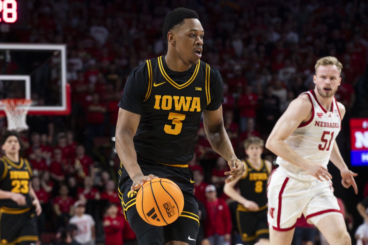 Iowa forward Cam Manyawu dribbles the ball during a basketball game between the Iowa Hawkeyes and the No.9 Nebraska Cornhuskers at Pinnacle Bank Arena in Lincoln, NE, on Sunday, March 8, 2026. At halftime, the Cornhuskers lead the Hawkeyes 30-26.