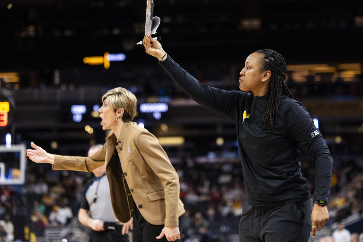 Iowa Hawkeyes head coach Jan Jensen and Iowa assistant coach Lasondra Barrett call out to the teamduring a basketball game between second-seeded Iowa and third-seeded Michigan at the Big Ten Women’s Basketball Tournament at Gainbridge Fieldhouse in Indianapolis on Saturday, March 7, 2026. The Hawkeyes defeated the Wolverines, 59-42.