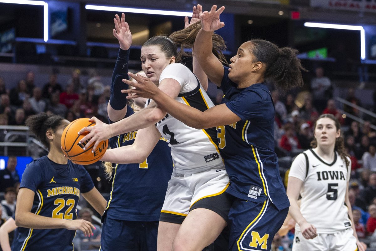Iowa Hawkeyes guard Taylor Stremlow (1) attempts to get past Michigan defenders during a basketball game between second-seeded Iowa and third-seeded Michigan at the Big Ten Women’s Basketball Tournament at Gainbridge Fieldhouse in Indianapolis on Saturday, March 7, 2026. The Hawkeyes defeated the Wolverines, 59-42.