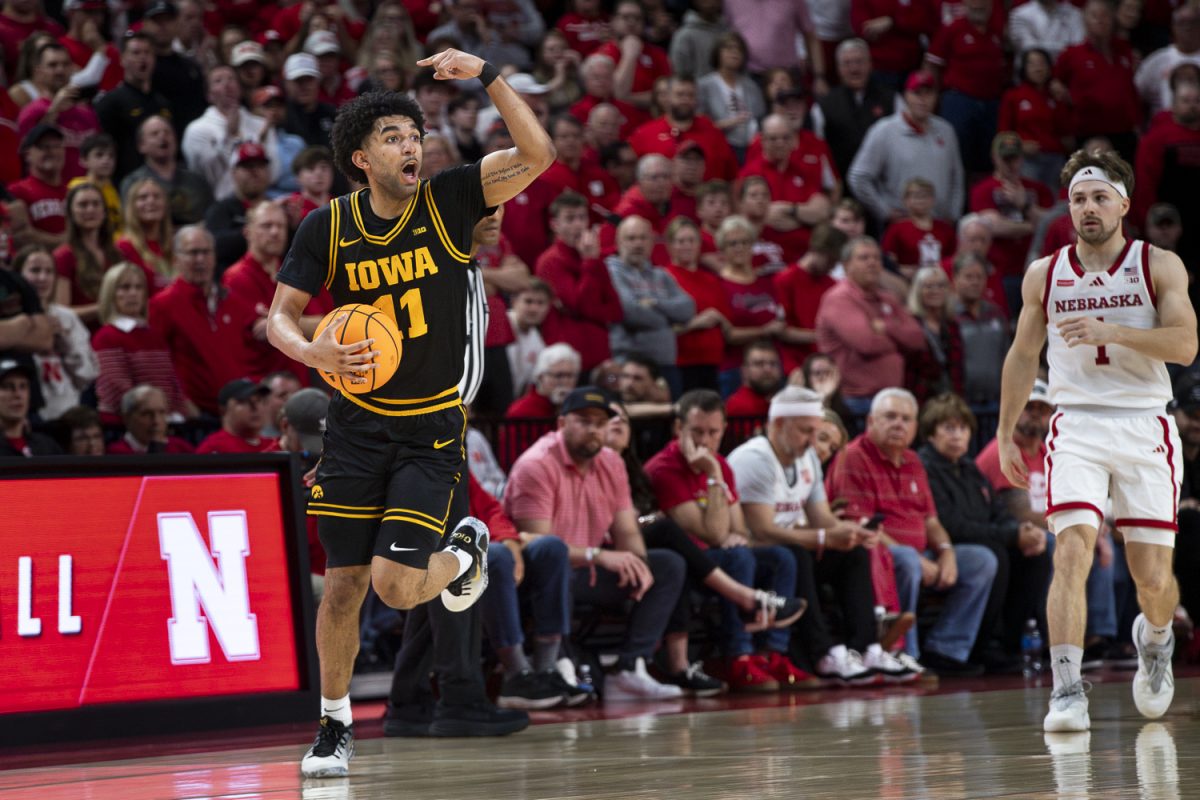 Iowa guard Kael Combs signals to review a call during a basketball game between the Iowa Hawkeyes and the No.9 Nebraska Cornhuskers at Pinnacle Bank Arena in Lincoln, NE, on Sunday, March 8, 2026. The Cornhuskers defeated the Hawkeyes 84-75 in overtime. Combs put up 18 points and was the go-to guy down the stretch. (Ethan McLaughlin/The Daily Iowan)