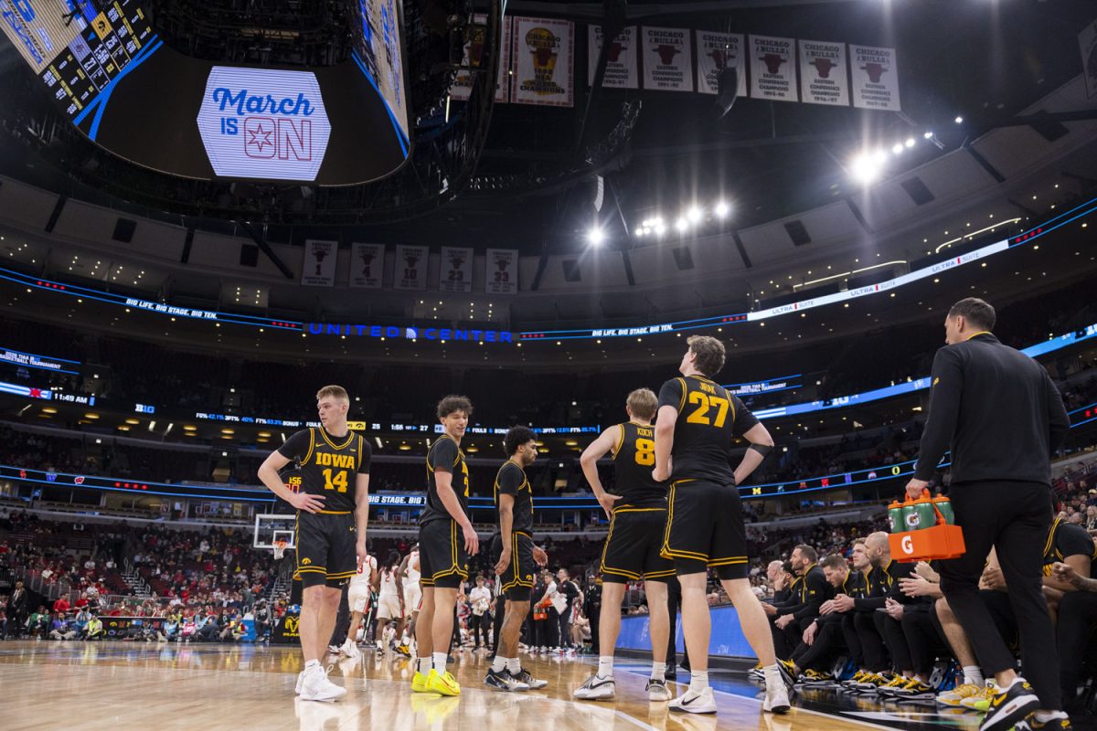 The Iowa team waits for the verdict of a call under review during a basketball game between the No. 9 seed Iowa Hawkeyes and the No. 8 seed Ohio State Buckeyes at the United Center in Chicago, Illinois on Thursday, March 12, 2026. The Buckeyes defeated the Hawkeyes, 72-69. (Samantha DeFily/The Daily Iowan)
