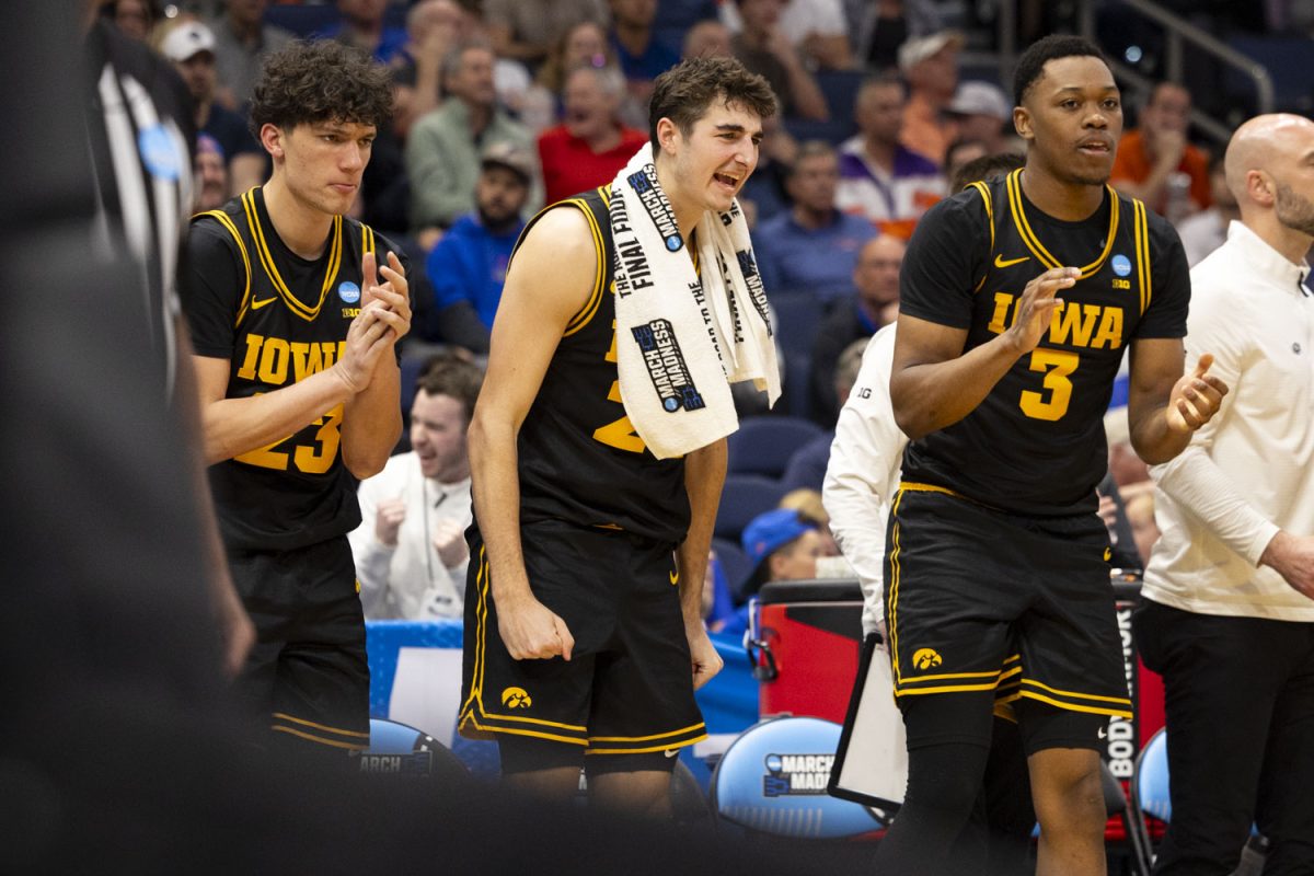 Iowa guards Isaia Howard, Tate Sage, and forward Cam Manyawu celebrate on the bench during a basketball game between the No. 9 seed Iowa Hawkeyes and the No. 8 seed Clemson Tigers at the Benchmark International Arena in Tampa, Florida on Friday, March 20, 2026. The Hawkeyes defeated the Tigers, 67-61. (Samantha DeFily/The Daily Iowan)