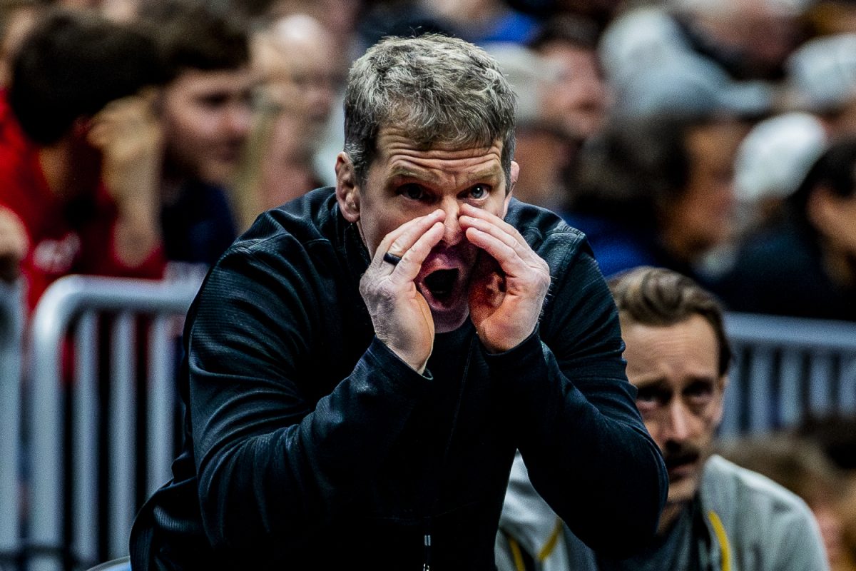 Iowa Head Coach Tom Brands gives 133-pounder Drake Ayala pointers during session four of the NCAA Division I Wrestling Championships at Rocket Mortgage FieldHouse in Cleveland, Ohio on Friday, March 20, 2026. (Reece Schrader/Daily Iowan)