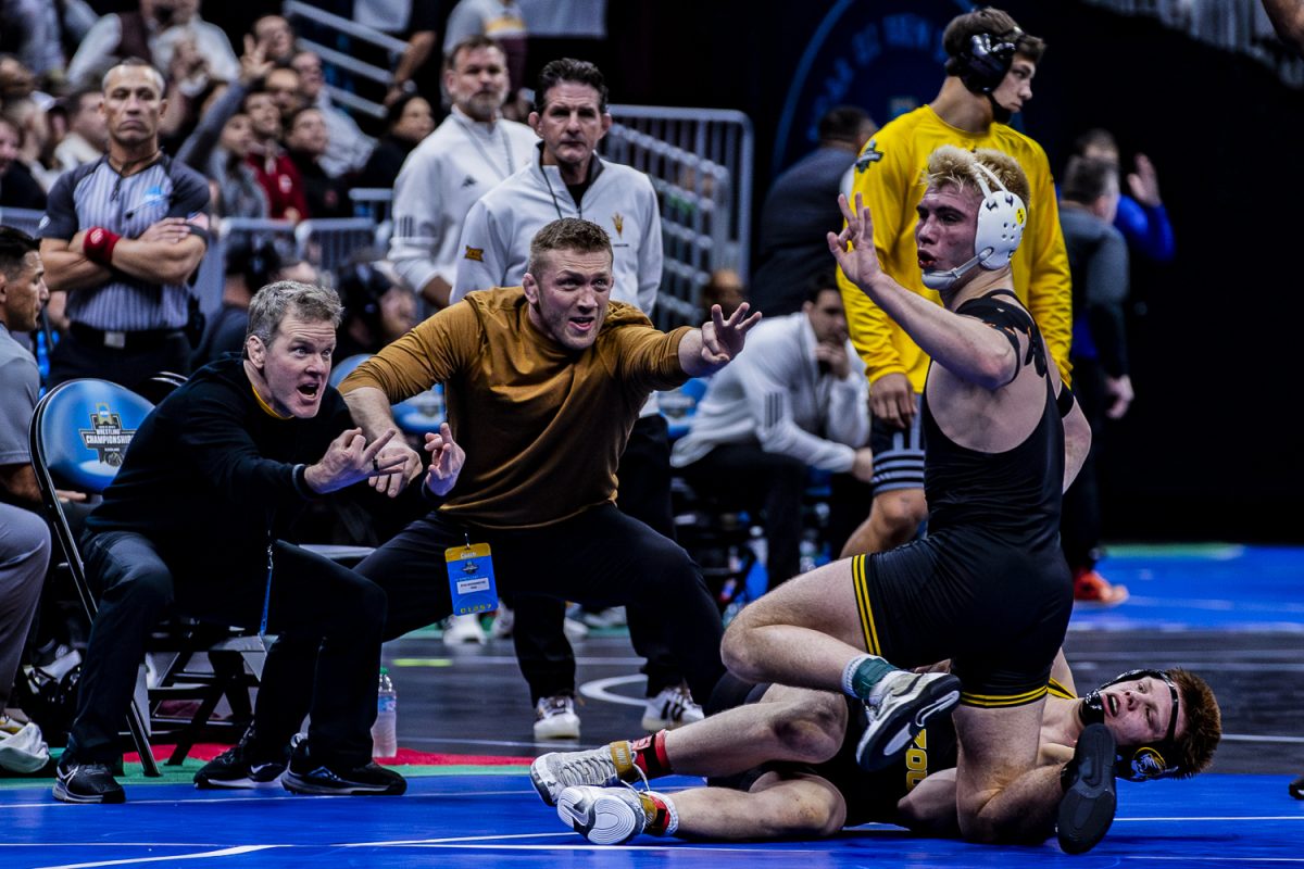 Iowa 184-pounder, No. 7 Angelo Ferrari motions three after taking down Missouri’s Aeoden Sinclair in the quarterfinals of the NCAA Division I Wrestling Championships at Rocket Mortgage FieldHouse in Cleveland, Ohio on Friday, March 20, 2026. Ferrari defeated Sinclair in a 4-1 sudden victory. (Reece Schrader/Daily Iowan)