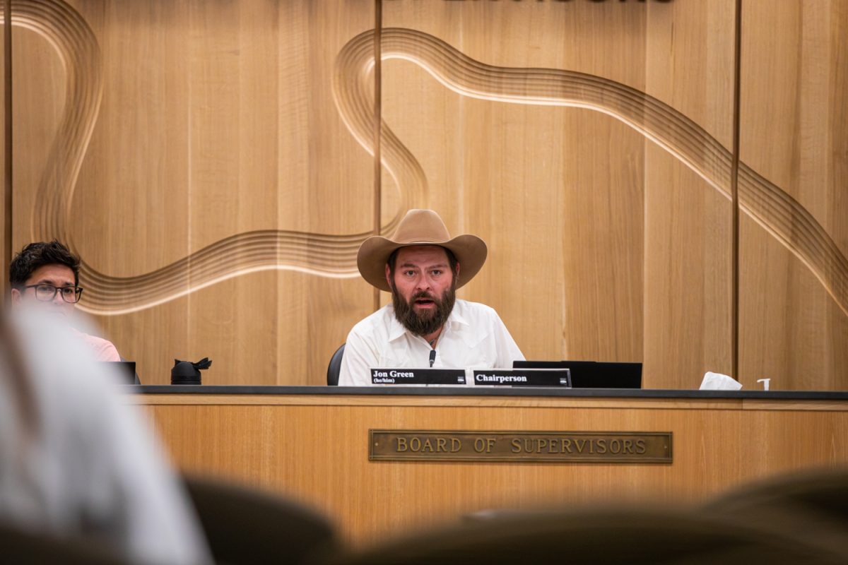 Jon Green, chair of the Johnson County Board of Supervisors, converses with a citizen during the tax levy public hearing. Residents of Johnson County brought challenges they face to the board of supervisors on Wednesday, March 25, 2026. (Dexter Westbay/The Daily Iowan)