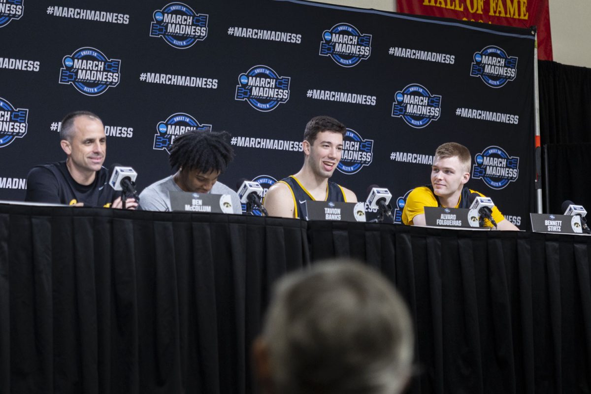 Iowa head coach Ben McCollum, guard Tavion Banks, forward Alvaro Folgueiras, and guard Bennett Stirtz speak with reporters during media availability with the No. 9 seed Iowa Hawkeyes and the No. 3 seed Illinois Fighting Illini at the Toyota Center in Houston, Texas on Friday, March 27, 2026. The Hawkeyes and Fighting Illini will face off on Saturday, March 28, at 5:09pm CST. (Samantha DeFily/The Daily Iowan)