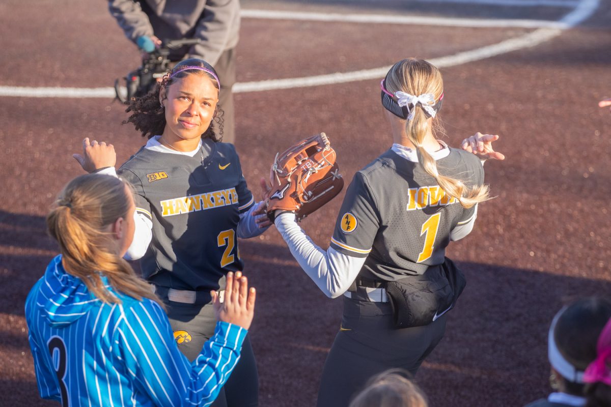 Iowa third basemen Avery Jackson celebrates with right fielder Tory Bennett before the softball game between Iowa and No. 16 Washington on Friday, March 27, 2026. This is the third series at Bob Pearl Field for the Hawkeyes this season. The Huskies handed the Hawks their biggest defeat of the season so far with a 16-7 win over Iowa.