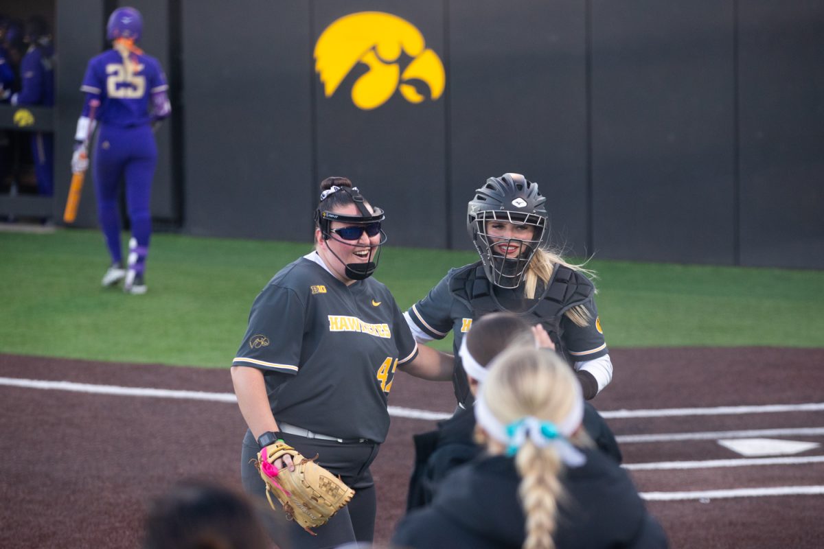 Iowa pitcher Serayah Neiss and catcher Leah McAnally celebrate three strikeouts at the softball game between Iowa and No. 16 Washington on Friday, March 27, 2026. McAnally had a run, three hits, and six putouts with an assist against Washignton. The Huskies handed the Hawks their biggest defeat of the season so far with a 16-7 win over Iowa.(Travis Crabb/The Daily Iowan)