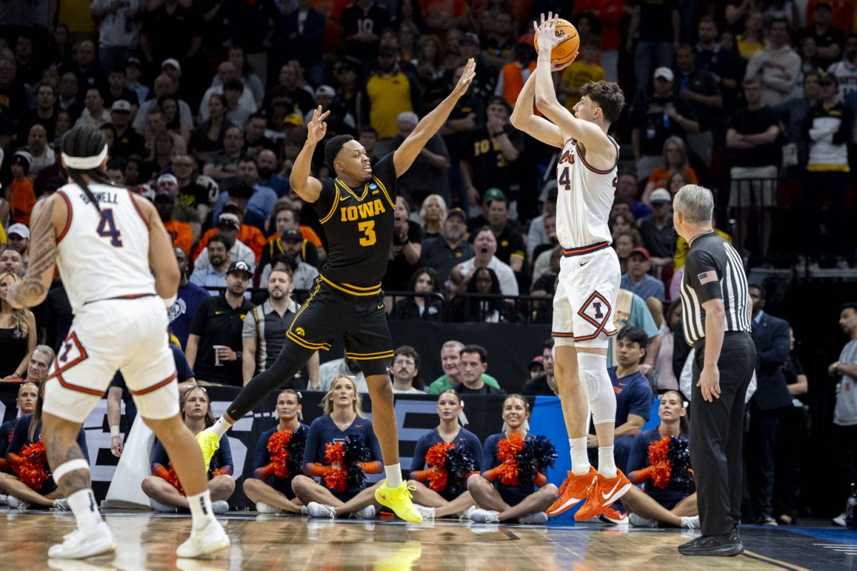 Iowa forward Cam Manyawu attempts to block a shot from Illinois forward Zvonimir Ivisic during a basketball game between the No. 9 seed Iowa Hawkeyes and the No. 3 seed Illinois Fighting Illini at the Toyota Center in Houston, Texas on Saturday, March 28, 2026. The Hawkeyes fell to the Fighting Illini, 71-59. (Samantha DeFily/The Daily Iowan)