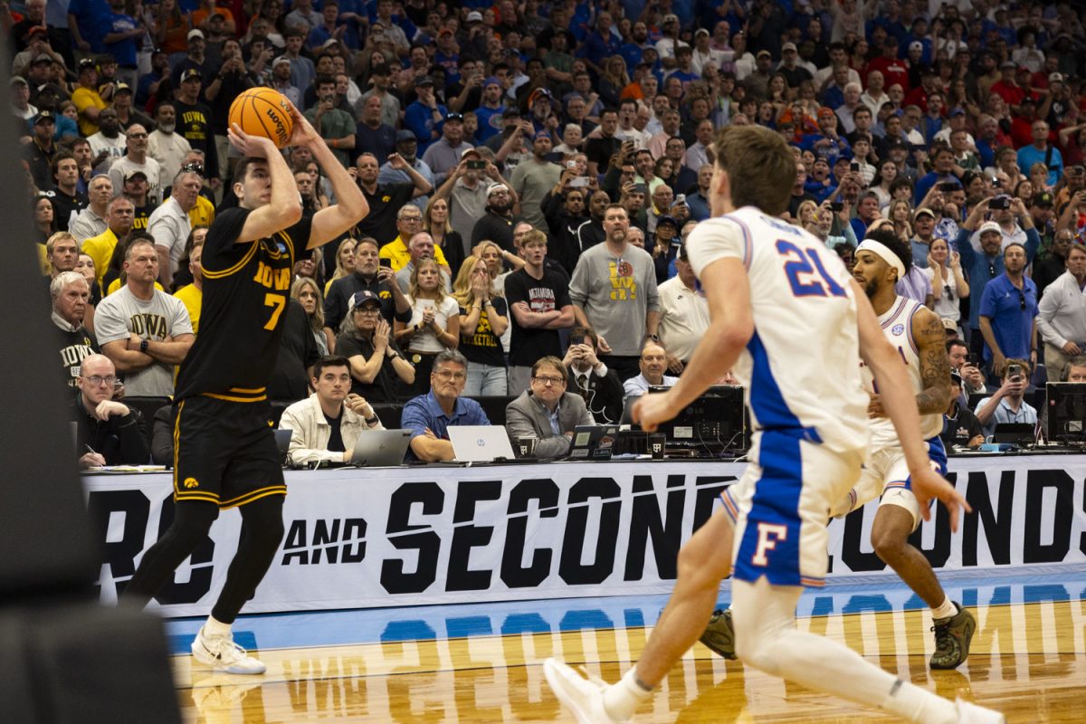 Fans watch as Iowa forward Alvaro Folgueiras attempts to shoot a three pointer during a basketball game between the No. 9 seed Iowa Hawkeyes and the No. 1 seed Florida Gators at the Benchmark International Arena in Tampa, Florida on Sunday, March 22, 2026. The Hawkeyes upset the Gators, 73-72. (Samantha DeFily/The Daily Iowan)