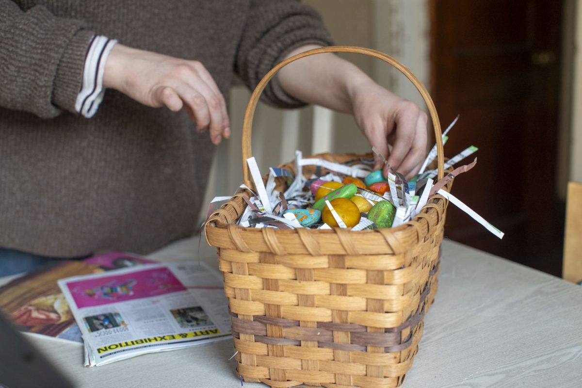 Laurel Preston puts together an egg basket of sustainable materials for Easter in Iowa City on Wednesday, April 9, 2025.