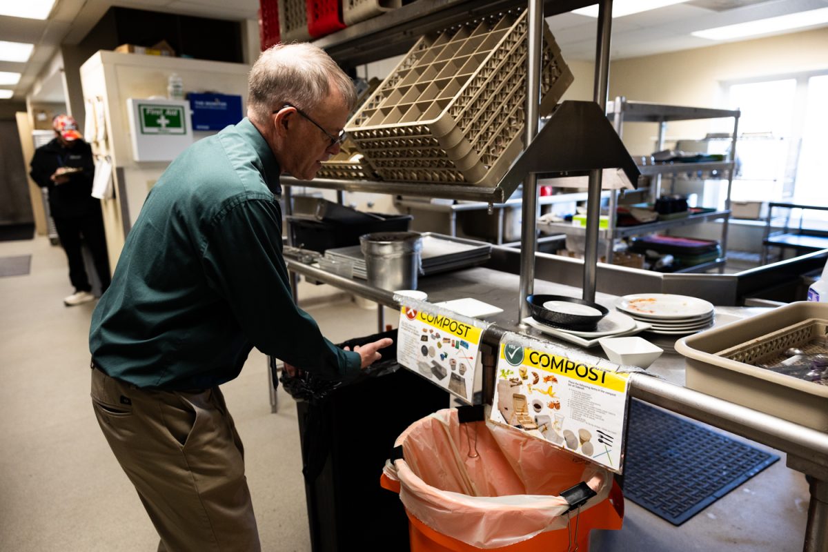 Bruce Titus, director of dining services at Oaknoll Retirement Residence, checks out the compost bins in Oaknoll’s kitchen on Thursday, March 12, 2026 in Iowa City, Iowa. Titus said Oaknoll has been composting food for about a year and a half. (Liz Sleper/The Daily Iowan).
