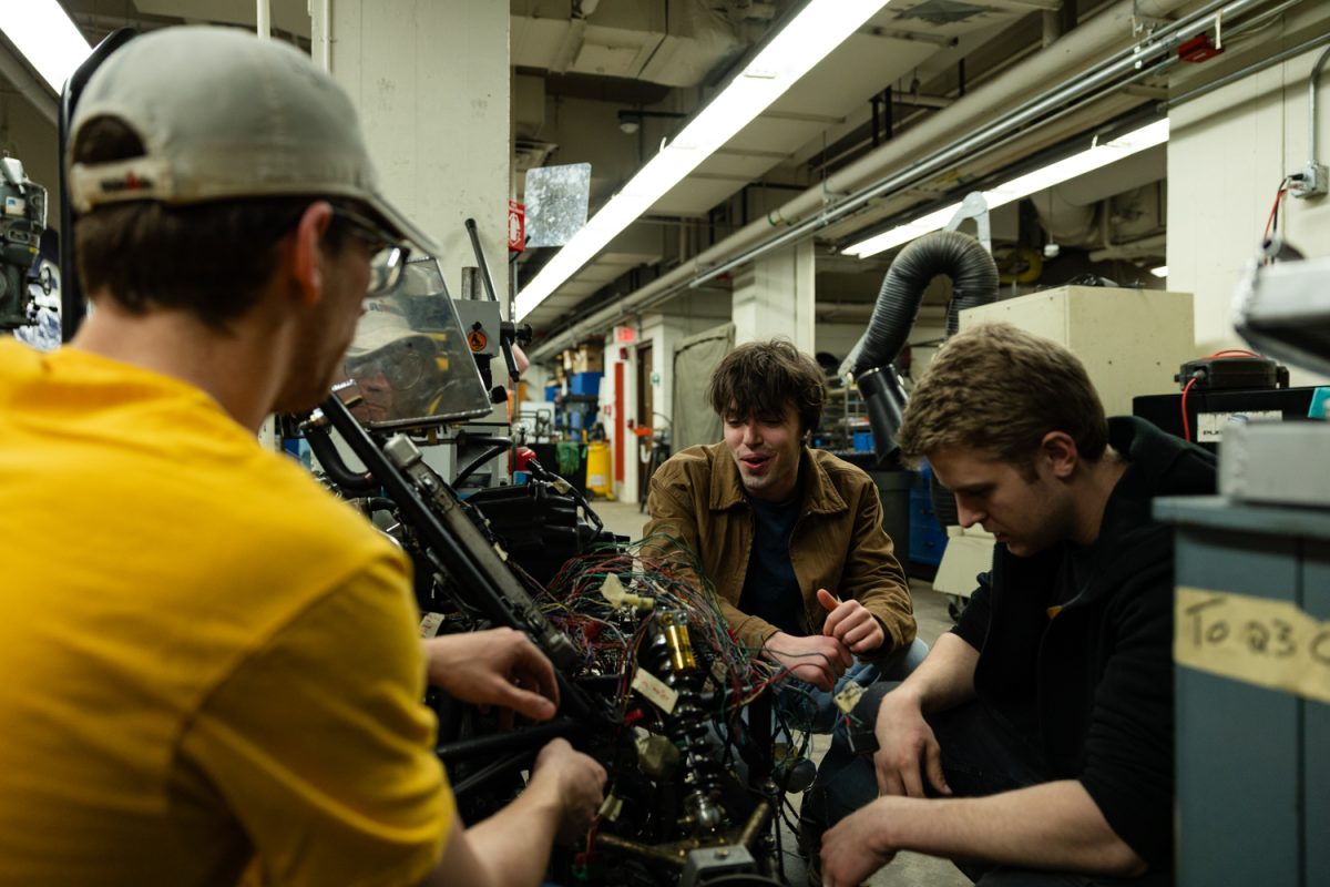 Members of the club work together on wiring the Iowa Formula Racing team’s show car in the Baja Shop in the Chemistry Building on Tuesday, March 10, 2026. The team plans to use their show car to recruit more members, and they plan to race in the Formula SAE competition in spring of 2027. (Liz Sleper/The Daily Iowan)