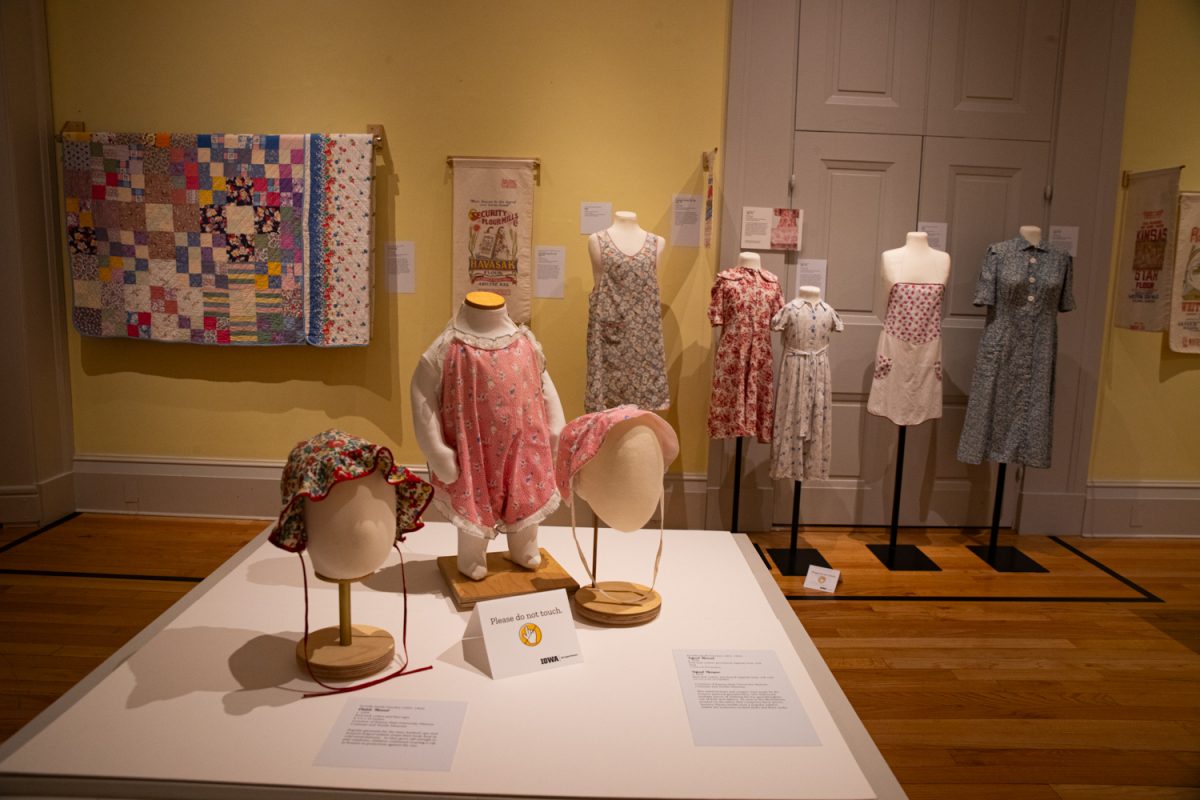 Antique clothing items are displayed at “Thrift Style,” a new exhibit at the Old Capitol Museum on Thursday, April 9, 2026. The Great Depression-era upcycled feed and sugar sacks were sourced from the Historic Costume and Textile Museum of Kansas State University. The exhibit is on display until August 11. (Ava Neumaier / The Daily Iowan).
