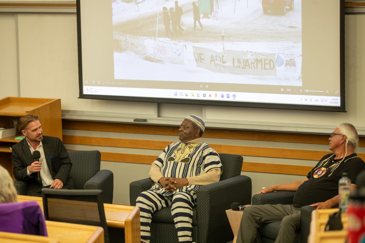 Host Aaron Page (left), Alfred Brownell (middle) and Tim Mentz Sr. (right) are seen together at the Heli Activism Panel at the Boyd Law Building on Friday, April 10, 2026.