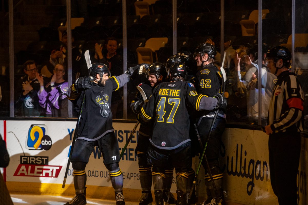 The Iowa Heartlanders hug and celebrate after scoring their third goal in the third period. The Iowa Heartlanders had a heartbreaking loss, losing 4-3 in overtime against the Bloomington Bison during their last game at Xtream Arena on Wednesday, April 15th, 2026 in Coralville, Iowa. (Sarah Hughes/The Daily Iowan)