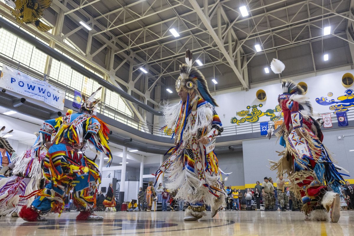 Dancers participate in the grand entry during the Iowa Powwow at the Fieldhouse in Iowa City on April 18, 2026. 