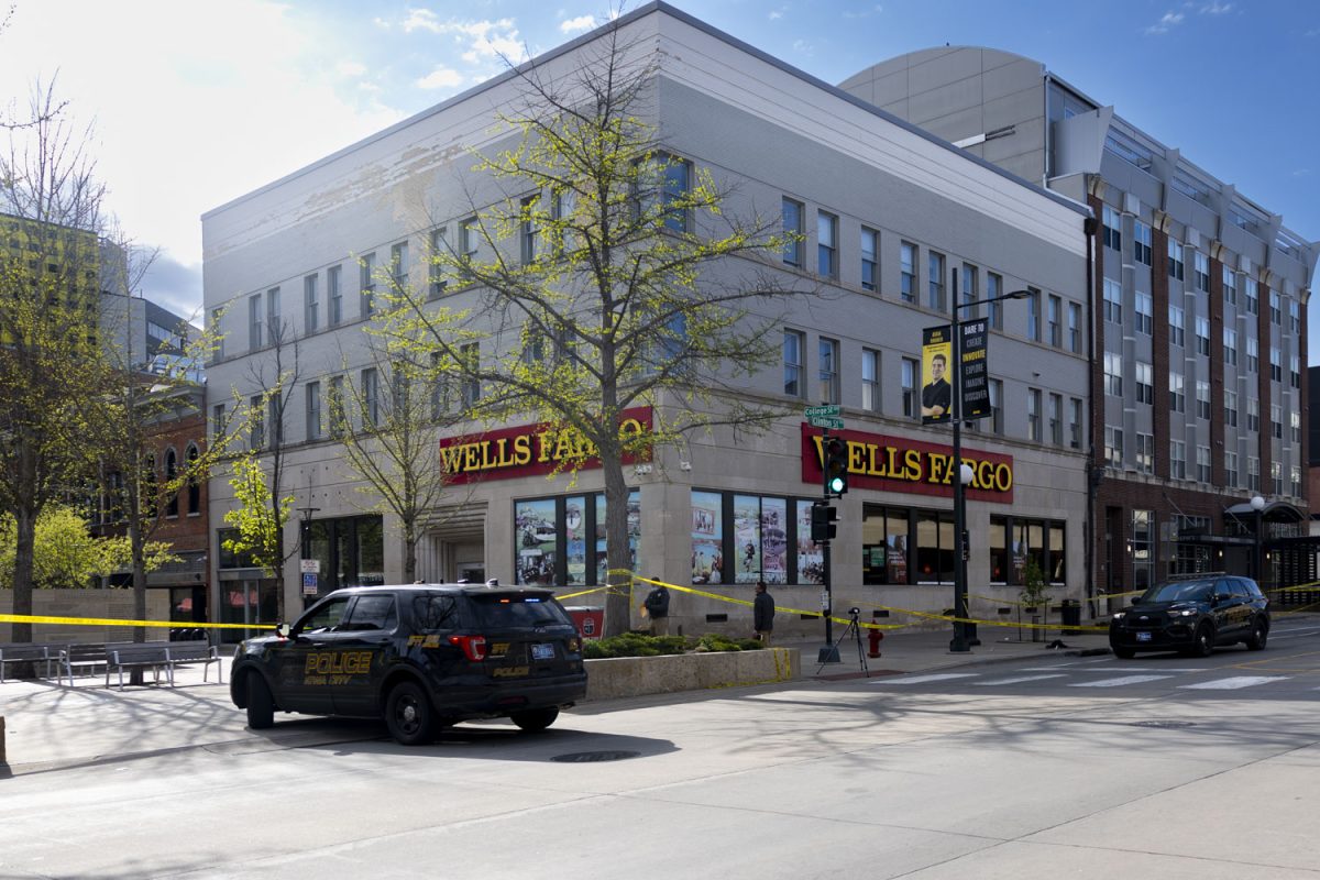 Police cars are stationed outside of a crime scene in the Pedestrian Mall Iowa City, Iowa on Sunday, April 19, 2026. Three students from the University of Iowa were injured in a shooting early Sunday morning.(Samantha DeFily/The Daily Iowan)