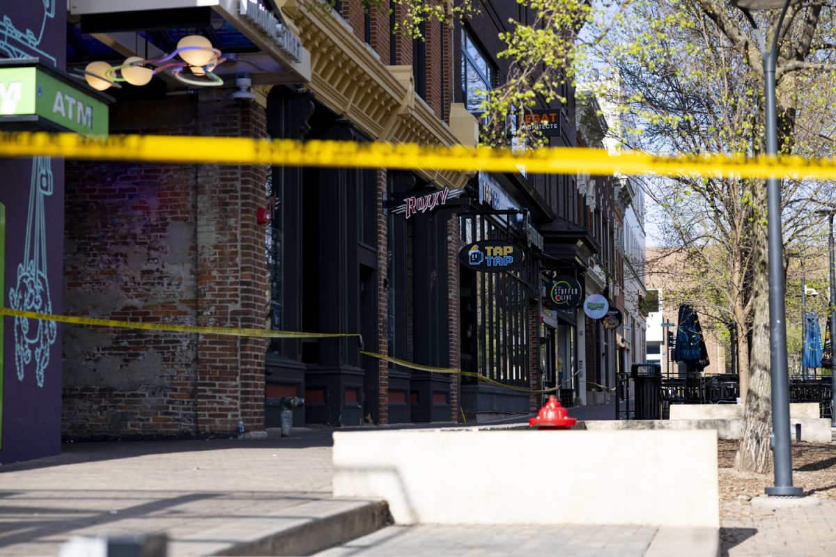 Police tape stretches across a crime scene in the Pedestrian Mall Iowa City, Iowa on Sunday, April 19, 2026. Three students from the University of Iowa were injured in a shooting early Sunday morning.(Samantha DeFily/The Daily Iowan)