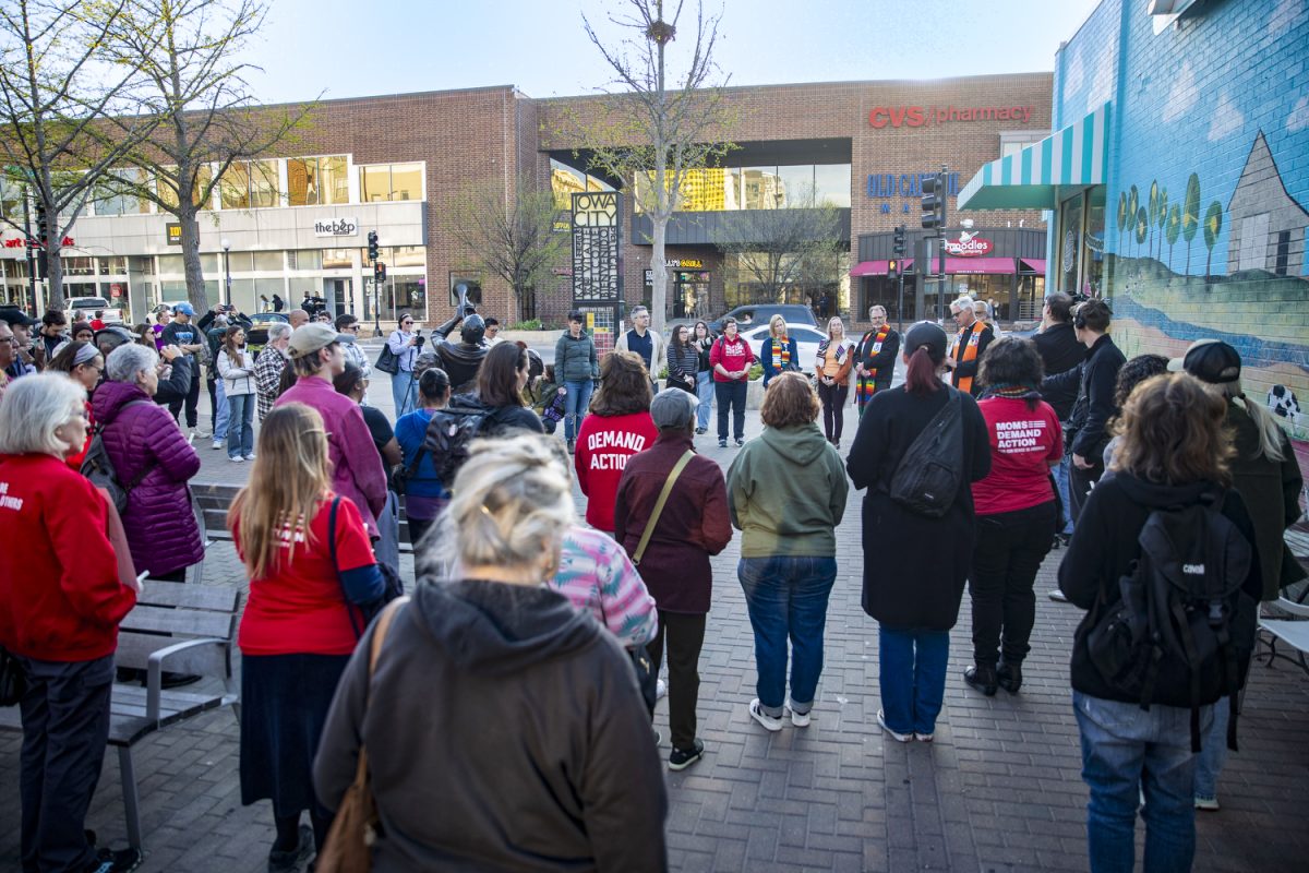 Attendees watch as religious community leaders speak during an Iowa City peace vigil at the Pedestrian Mall in Iowa City on Monday, April 20, 2026. The vigil follows a shooting on the morning of April 19 that injured three University of Iowa students. (Isabella Tisdale/The Daily Iowan)