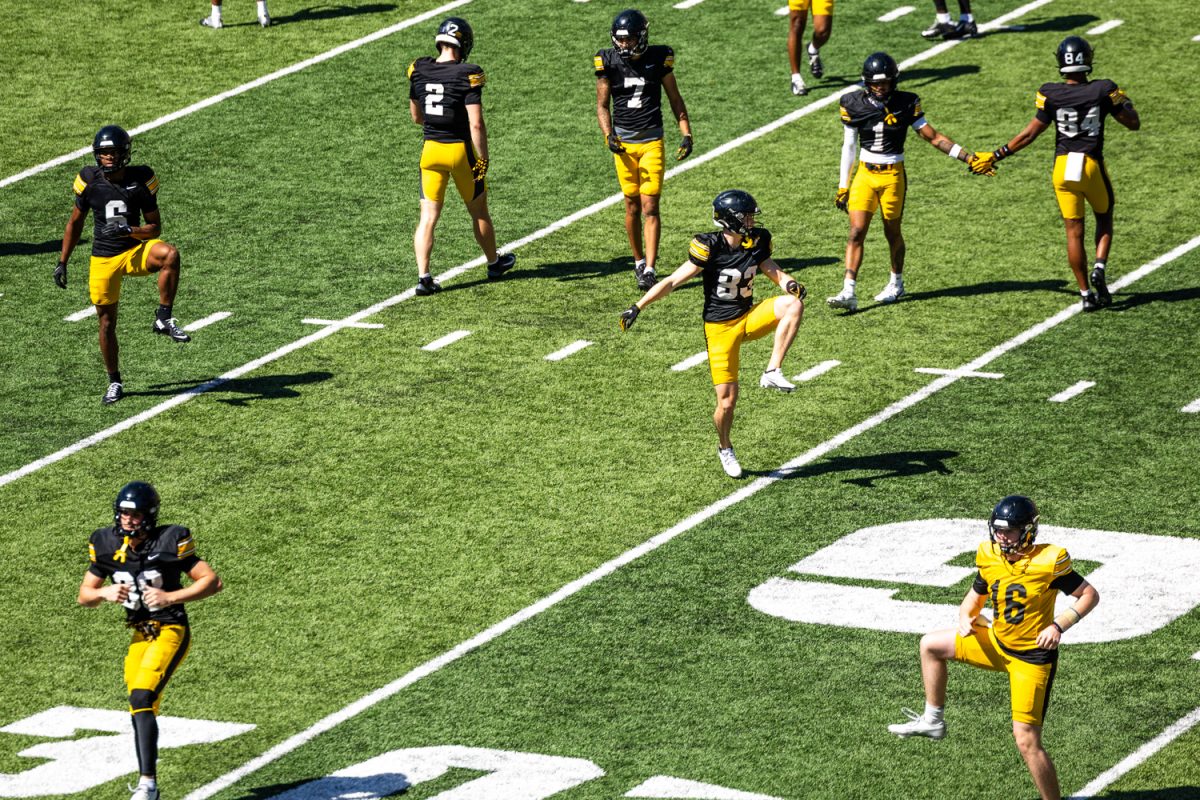 Iowa players warm up during football open practice at Kinnick Stadium in Iowa City on Saturday, April 25, 2026. The Iowa Hawkeyes host the Northern Illinois Huskies on Sept. 5 with the time yet to be announced. (Emma Calabro/The Daily Iowan)