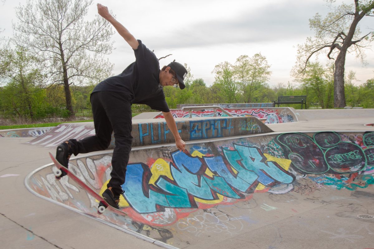 Andrew Tran practices axel stall on the edge of a ramp in the Iowa City Skate Park in Iowa City, Iowa, on Saturday, April 25, 2026. Andrew and his friends come to the skate park and practice often.