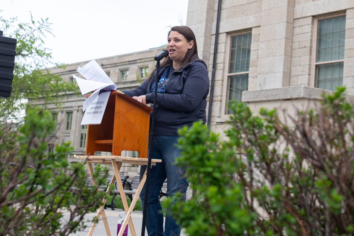 Dana Dominguez speaks during Take Back the Night, an annual march and protest to raise awareness for sexual assault survivors in Iowa City on Tuesday, April 28, 2026. The event is in its 50th year, and was attended by around one hundred participants. Dominguez is the Program Manager of Womens Resource & Action.(Ava Neumaier / The Daily Iowan)