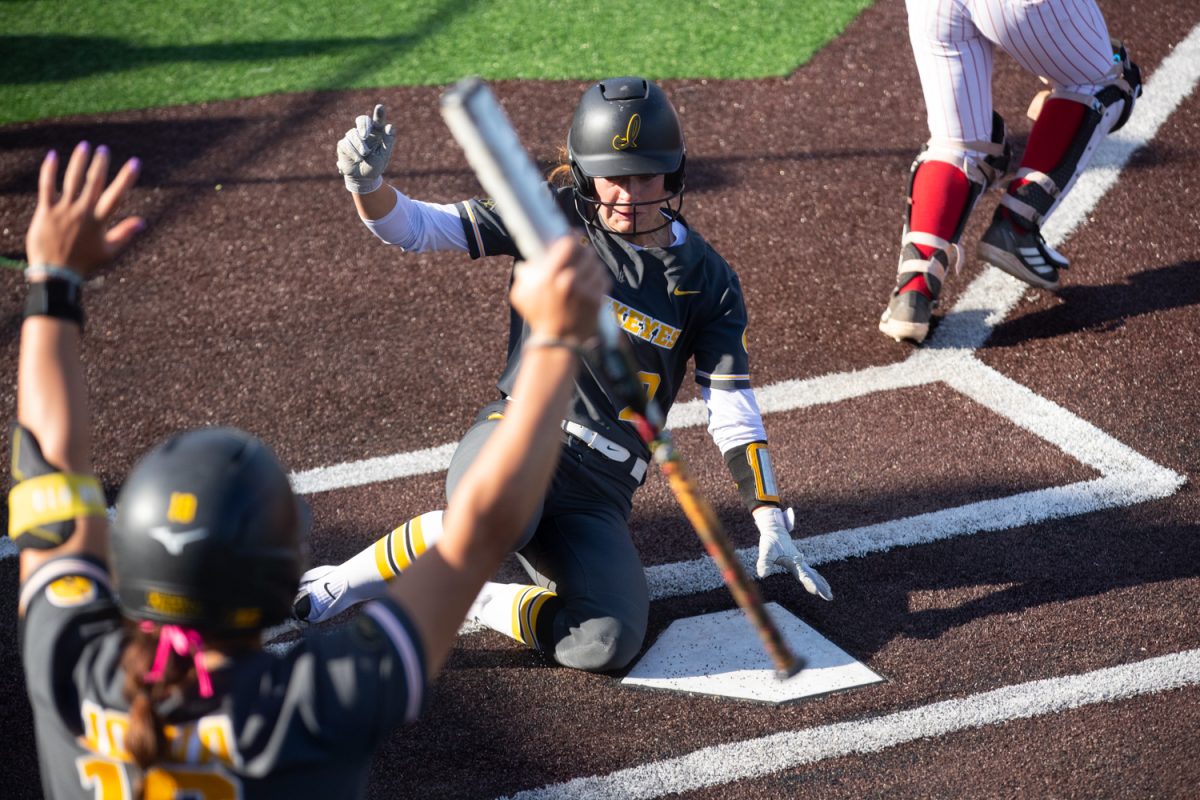 Hawkeye pinch runner Breanna Caffery slides into home during the Iowa versus Northern Illinois University softball game Wednesday April 29, 2026 at Bob Pearl Softball Field in Iowa City, Iowa. Caffrey played for DMACC Bears last season and recorded 54 stolen bases. The Iowa Hawkeyes won the game 10 to 2 after mercy ruling the Northern Illinois Huskies. This win makes the Hawkeyes 26-25 on the season. The Hawkeyes will face off against the Purdue Boilermakers on Friday May 1.(Annika Nelson/ The Daily Iowan)