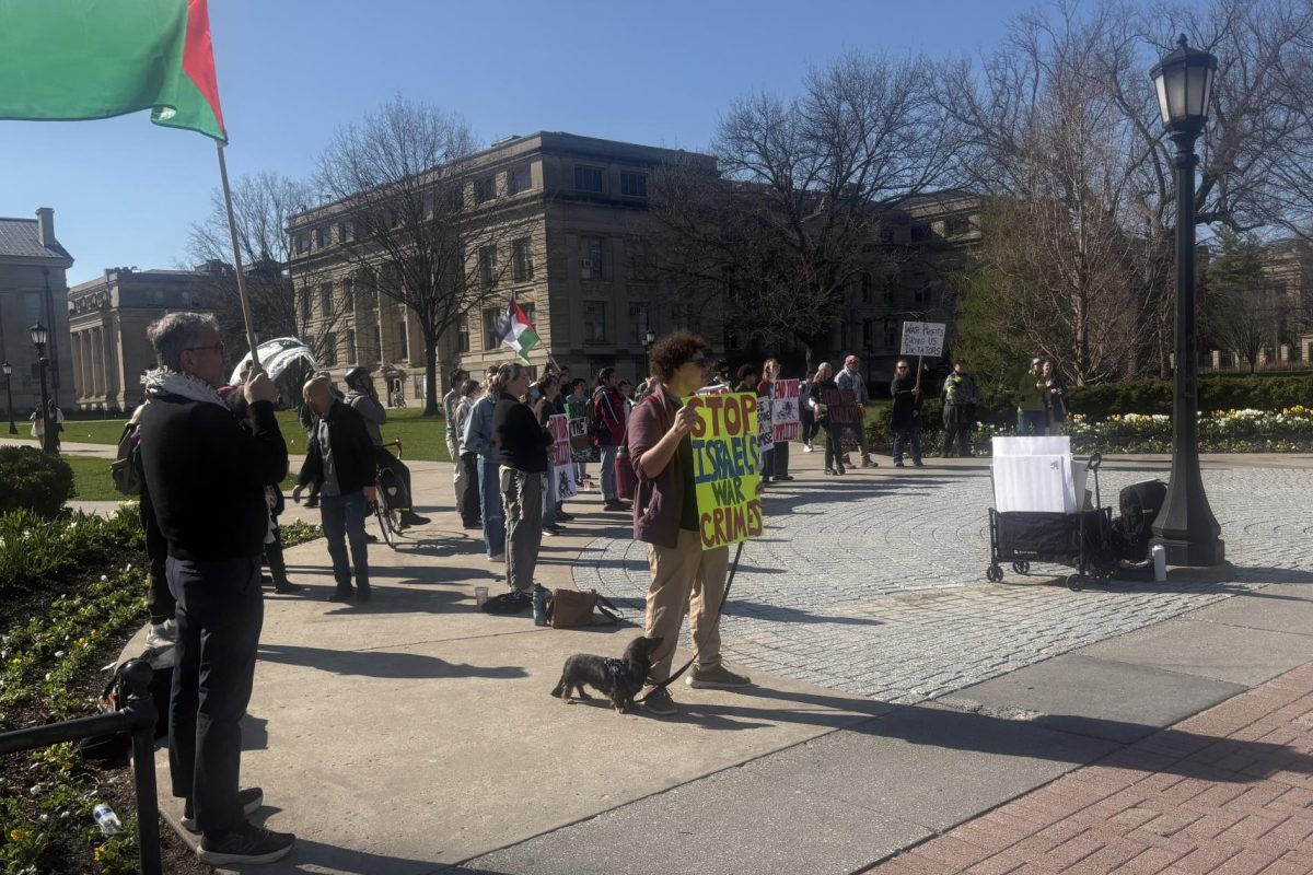 Protestors rally on the University of Iowa Pentacrest to protest the UI's relationship with companies that that contract for the U.S. and Israeli militaries on Friday, April 9, 2026. 