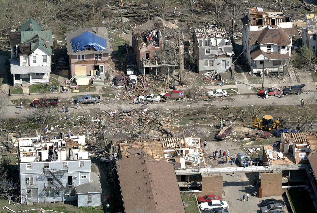 Ben Roberts/The Daily Iowan
Debris lays strewn about Iowa Avenue on Friday morning, Apr. 14, 2006. Although most homes will be repaired, many are damaged to the point of no return.