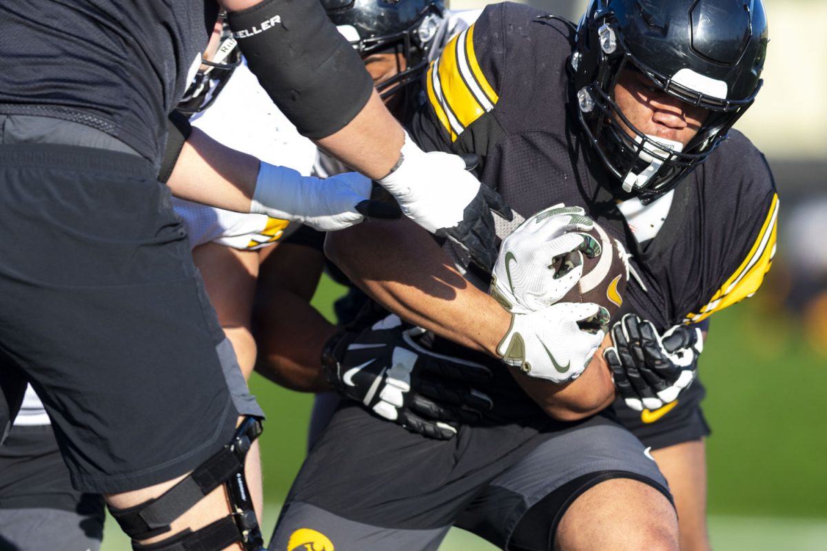 Iowa running back Xavier Williams attempts to get past defenders during an open practice for the media at the Ronald D. and Margaret L. Kenyon Football Practice Facility on Thursday, April 9, 2026. Open practice for fans is set for April 25 in Kinnick Stadium, gates open at 9:45am CST. (Samantha DeFily/The Daily Iowan)