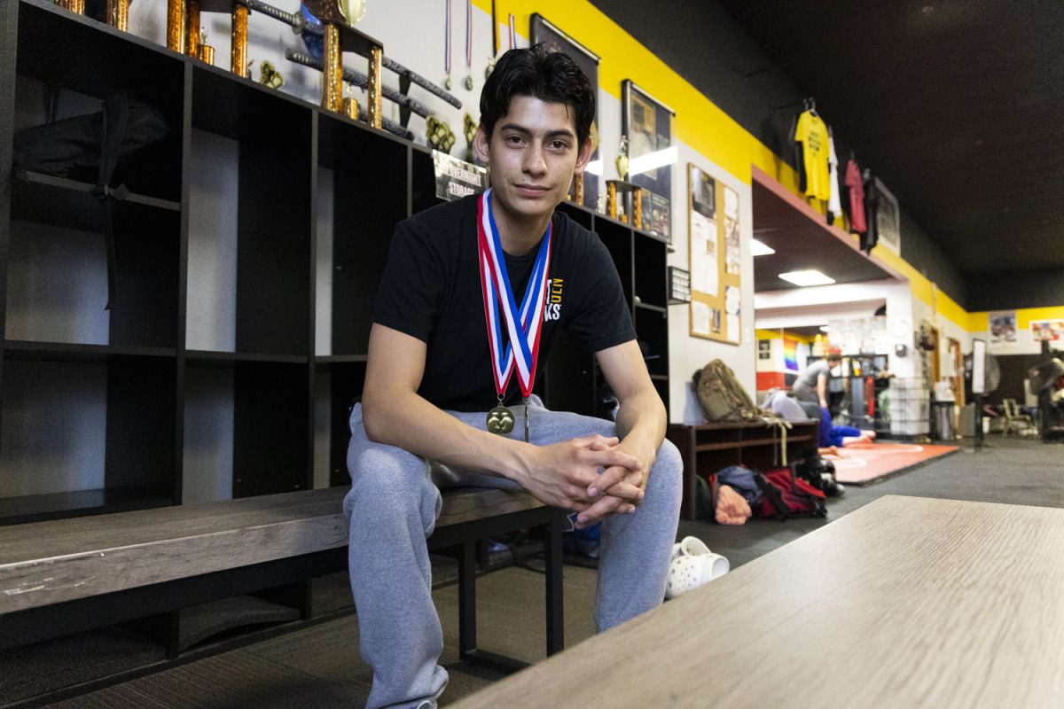 Luciano Cardozo-Torres poses for a portrait in Big George’s Boxing Gym in Iowa City on April 28. Cardozo-Torres currently has two medals, one from the regional championship and the other from placing second at the national tournament. (Samantha DeFily/The Daily Iowan)