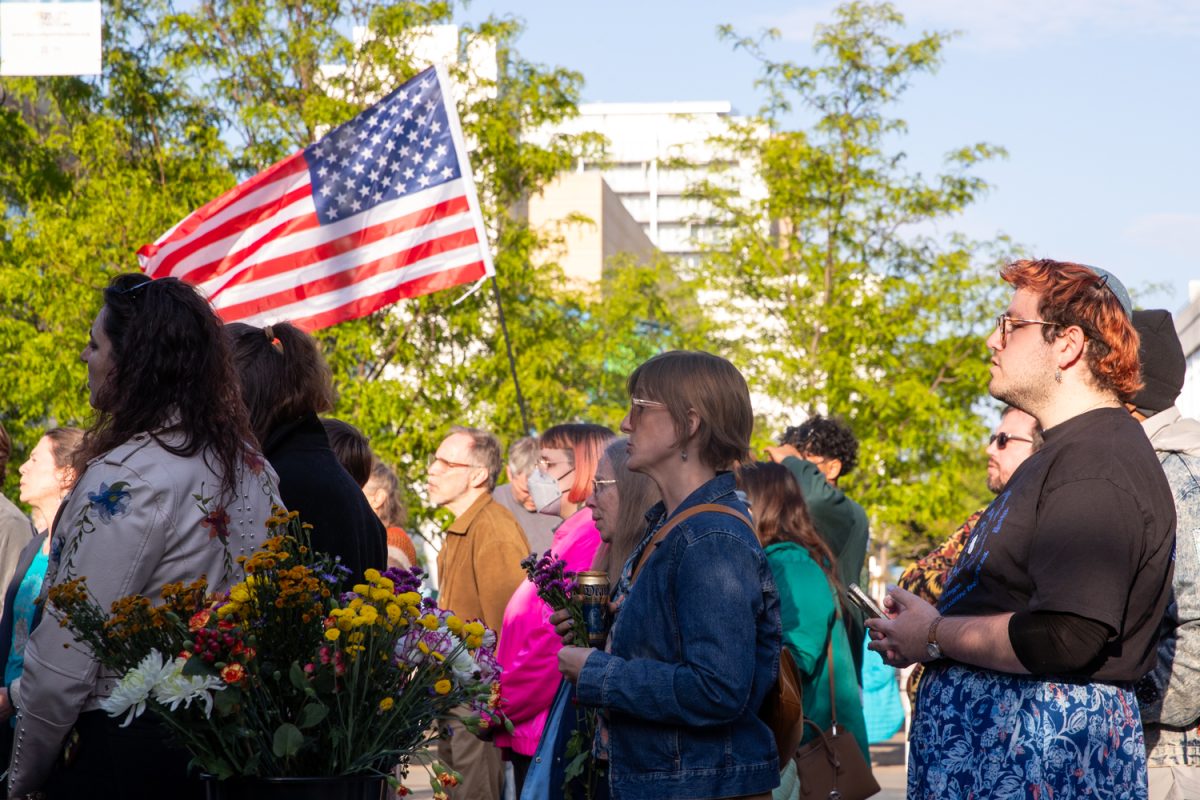 Community members join in song during the Singing Resistance Iowa City Vigil on Friday, May 1, 2026 on the Iowa City Pedestrian Mall. The vigil was hosted in honor of May Day and discussed issues about ICE, immigration policy, and the recent Iowa City shooting. (Annika Nelson/ The Daily Iowan)