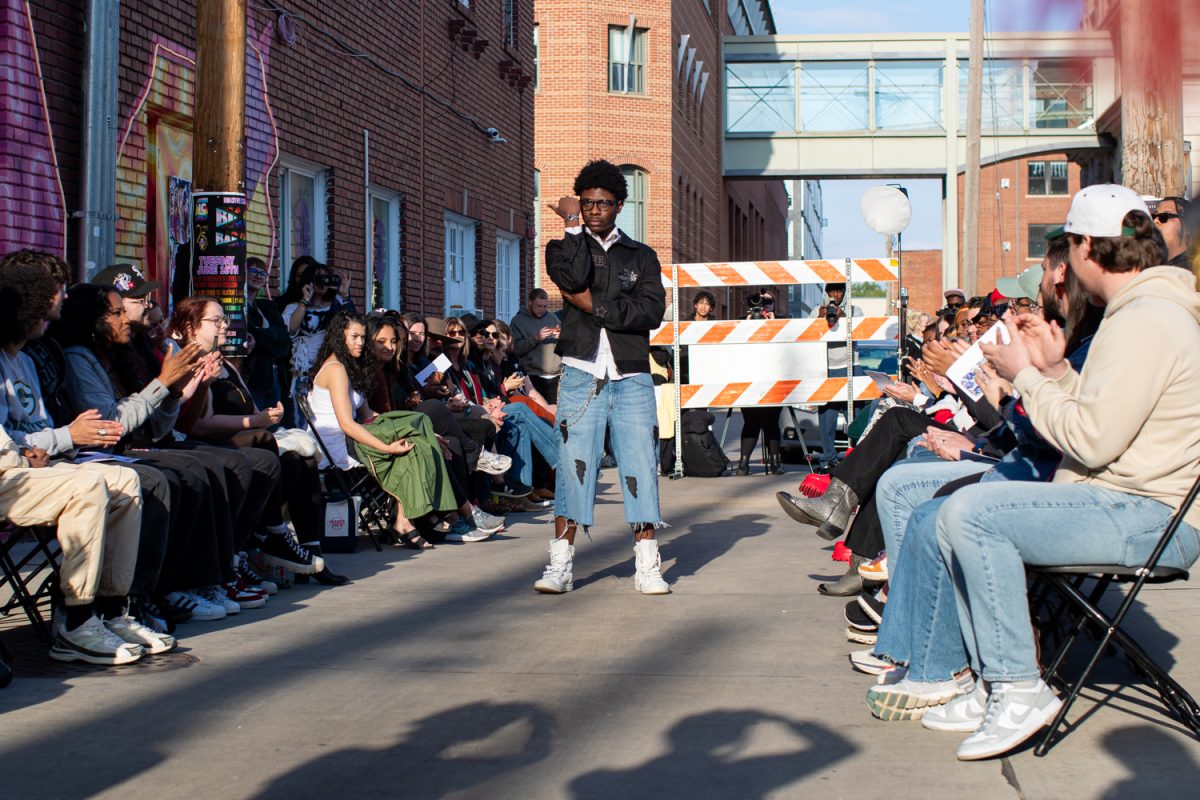Camani Nazir walks down the runway in Cope Apparel designer clothes during the Iowa City Beyond Fashion Fest 2 outside Studio 13 on Friday, May 1, 2026. This is the second year of the Fashion Fest, which runs from May 1-2 with fashion walks, markets, panels, and parties. (Ava Neumaier / The Daily Iowan)
