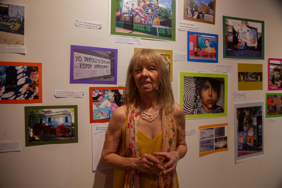 Artis Nora Garda poses for a portrait in front of her art works in the Broken Tiles Exhibition in Artifactory, in Iowa City, Iowa, on Friday, May 1, 2026. The exhibition is an interactive installation that displays Nora’s photographs of tiles in Argentina and other places. (Sal Yang/The Daily Iowan)