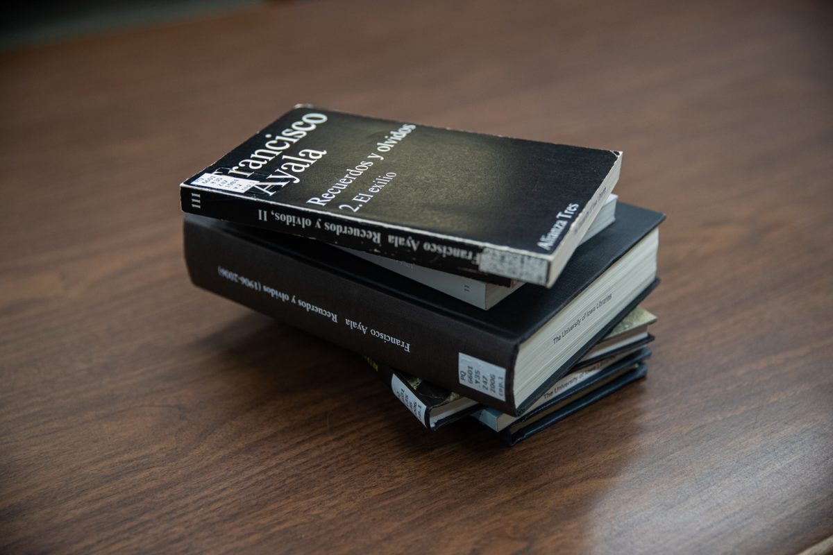 Books are seen stacked on a table at the University of Iowa library. (Dexter Westbay/ The Daily Iowan)