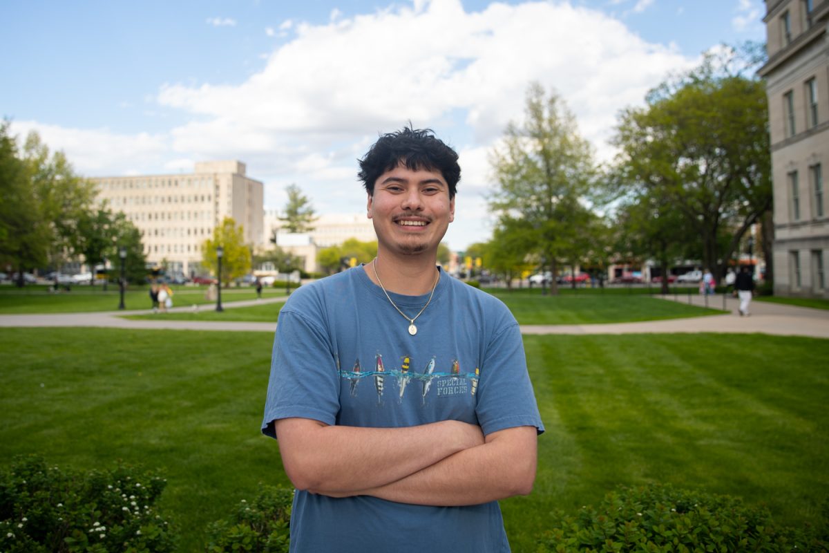 University of Iowa graduating senior Dave Cacho poses for a portrait in front of the Pentacrest on Thursday, May 7, 2026. Despite spending most of his time on politics, Cacho still found time for his passions of DJing and photography. (Travis Crabb/ The Daily Iowan)