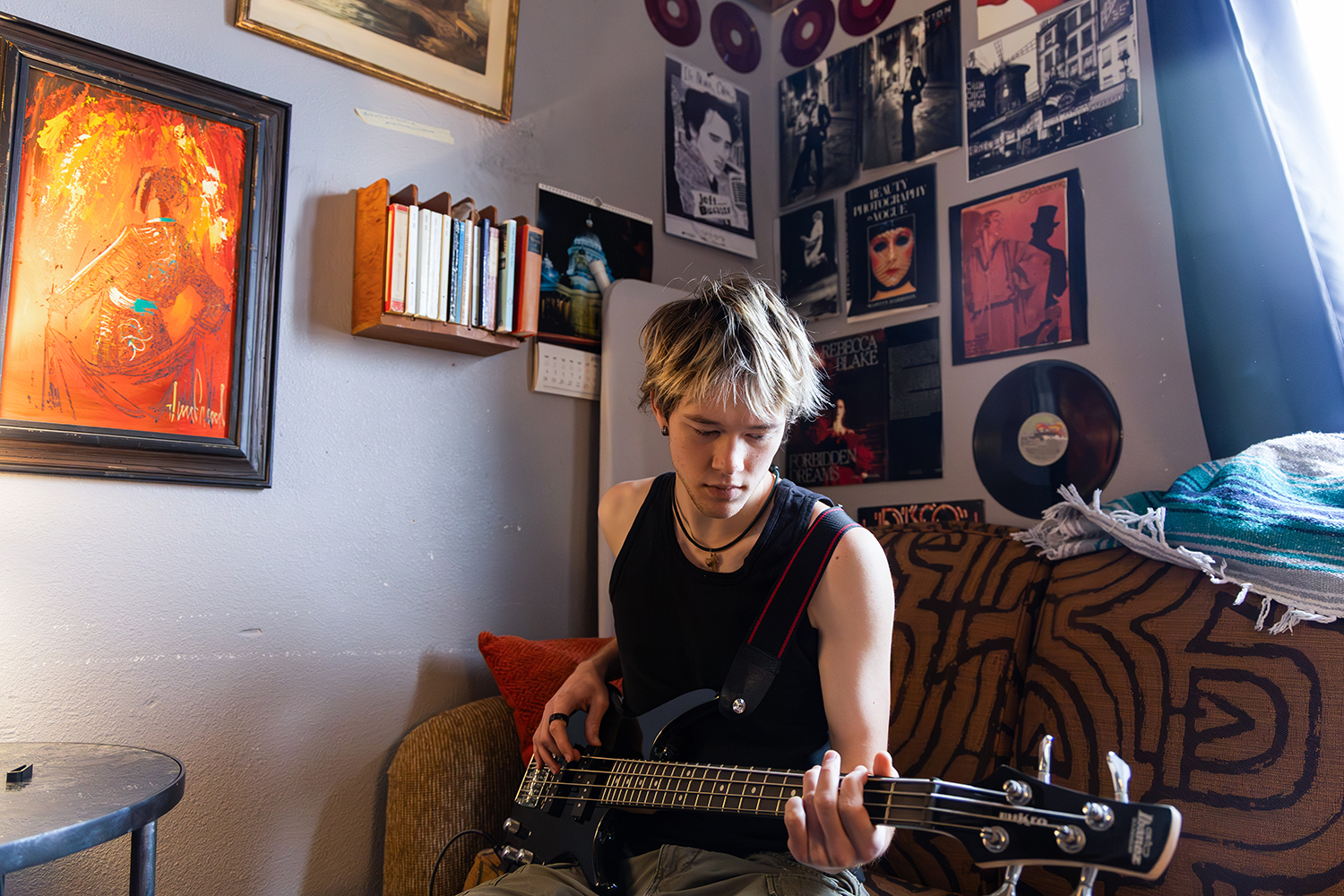 Luke Felix plays guitar in his room at a University of Iowa fraternity house, Thursday, Jan. 30, 2026. Felix, who taught himself how to play, picked up the instrument as a personal hobby. (Eddie Tepper / SJMC)
